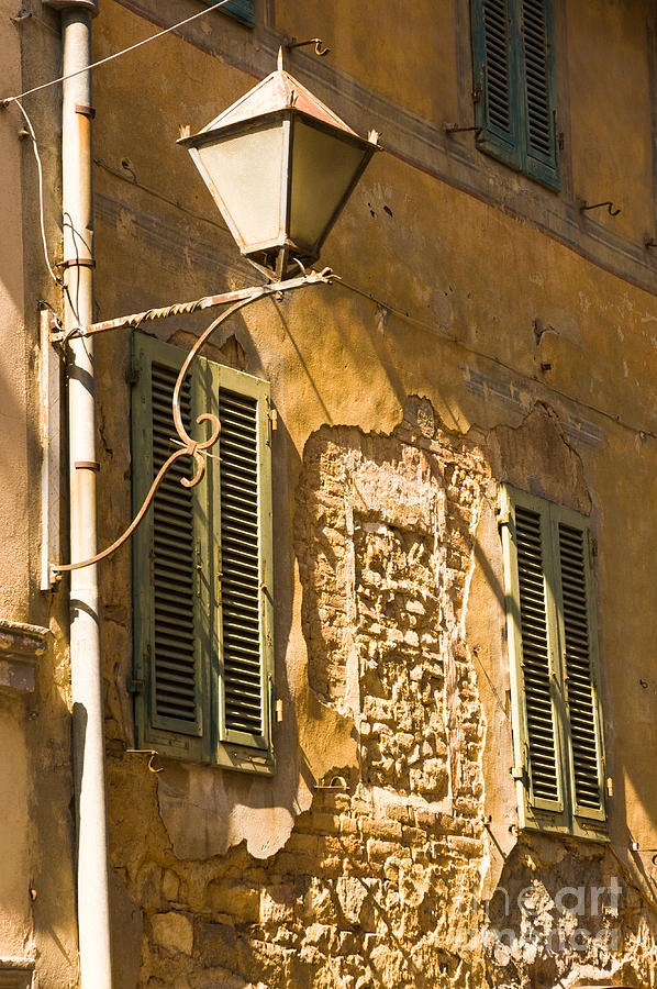 Italian old street lamp on dilapidated building with shutters Photograph by Peter Noyce