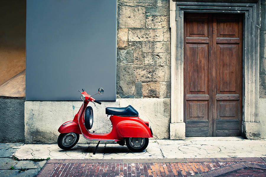 Italian vintage red scooter in front of a house Photograph by Deimagine