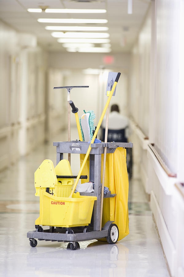 Janitorial cleaning cart in hospital corridor Photograph by ER Productions Limited