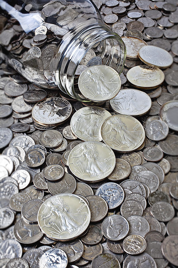 Jar spilling silver coins Photograph by Garry Gay