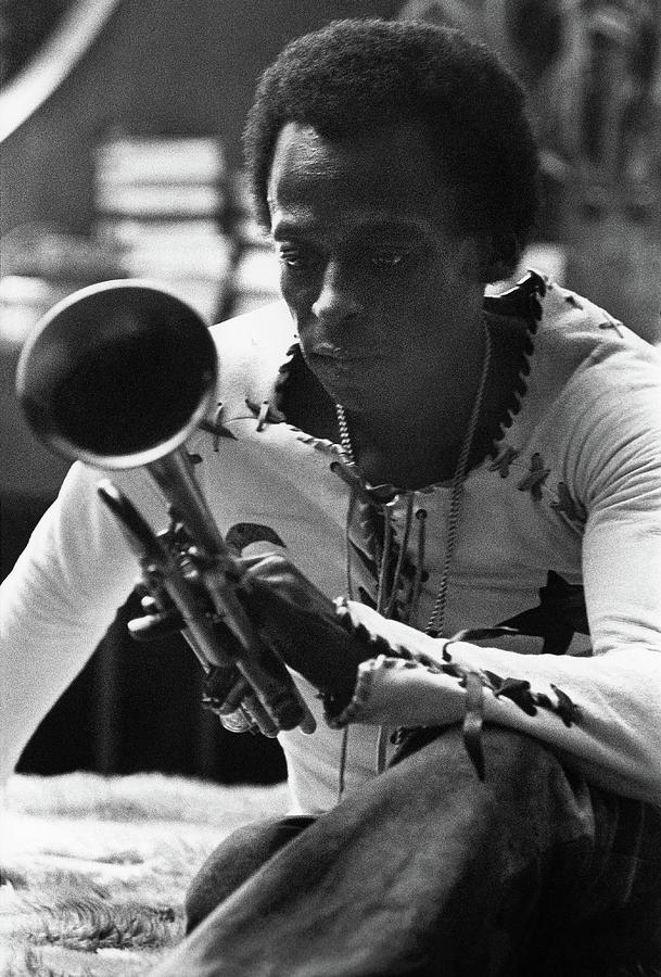Jazz Musician Miles Davis Looking At His Trumpet Photograph by Mark Patiky