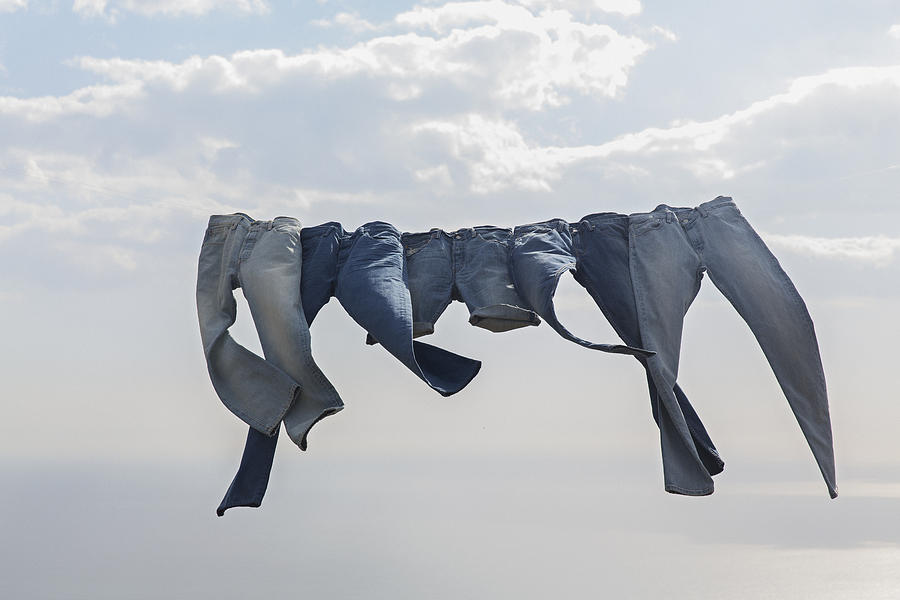 Jeans Hanging On A Clothesline In The Wind Photograph by Erik Von Weber