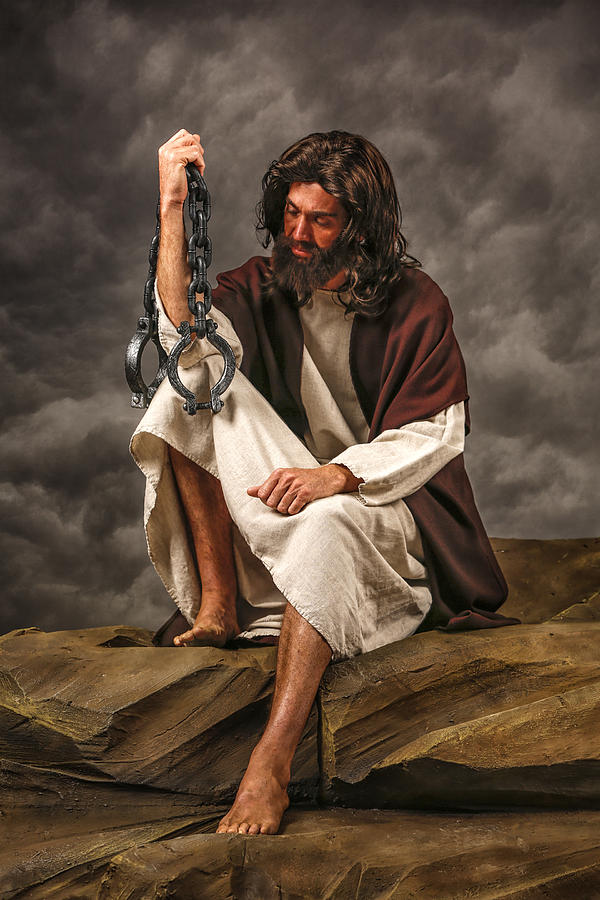 Jesus Sitting on rock holding chains Photograph by Inhauscreative