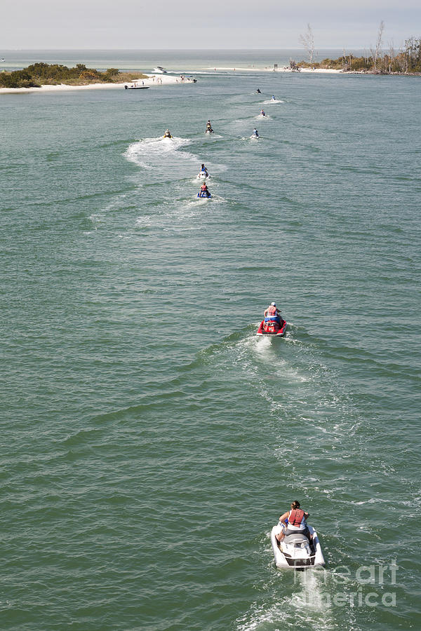Jet skis head out on Estero Bay towards the Gulf of Mexico near Fort Myers Florida Photograph by William Kuta