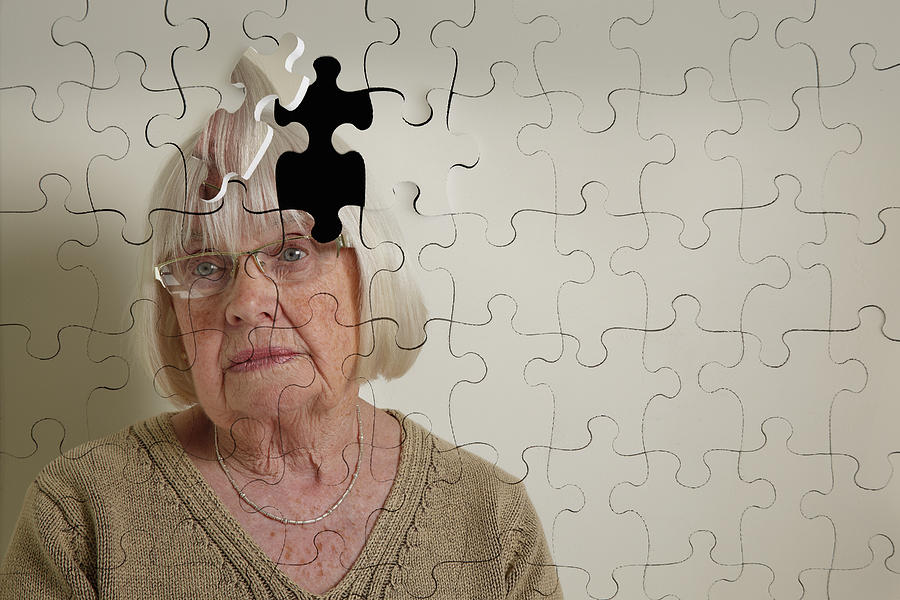 Jigsaw puzzle, of a senior woman, falling apart Photograph by Andrew Bret Wallis