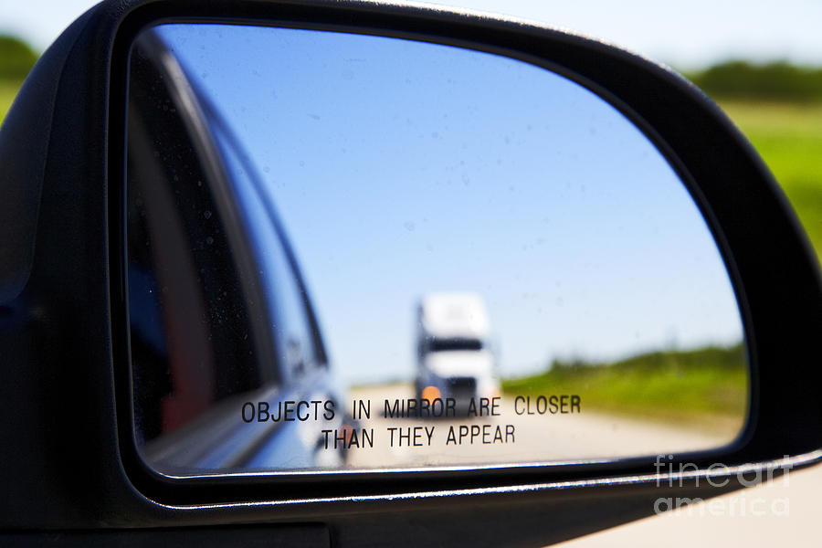 Transportation Photograph - Joe Fox Fine Art - objects in mirror are closer than they appear with following semi truck on canadian highway by Joe Fox