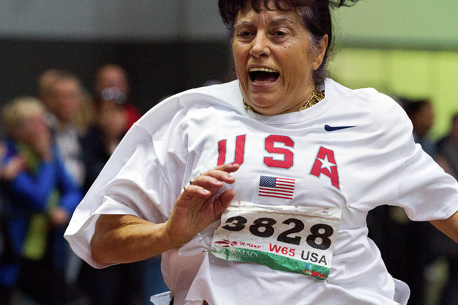 Joyful Older Female Athlete Running Photograph by Alex Rotas