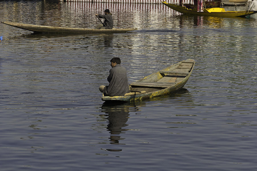 Kashmiri men rowing many small wooden boats in the waters of the Dal Lake Photograph by Ashish Agarwal