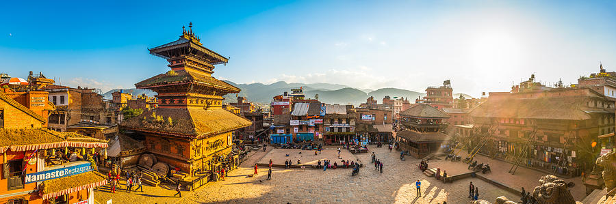Kathmandu ancient temples illuminated by golden sunset panorama Bhaktapur Nepal Photograph by fotoVoyager