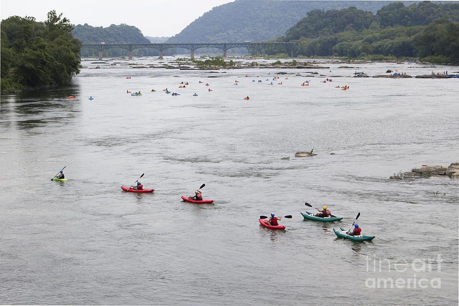 Kayakers and tubers ride the Shenandoah river into the Potomac at Harpers Ferry Photograph by William Kuta