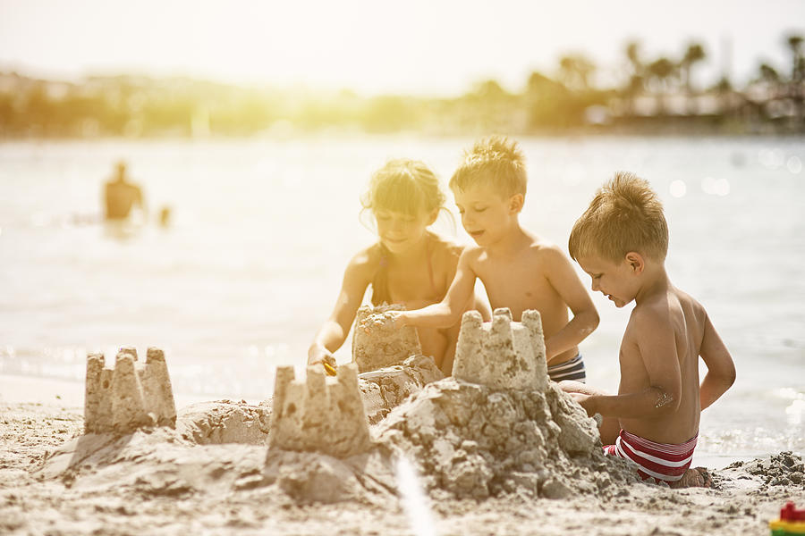 Kids building a sandcastle Photograph by Imgorthand