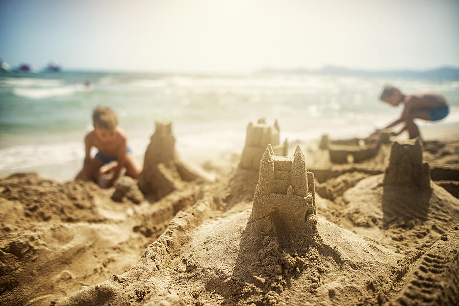 Kids building sandcastles Photograph by Imgorthand