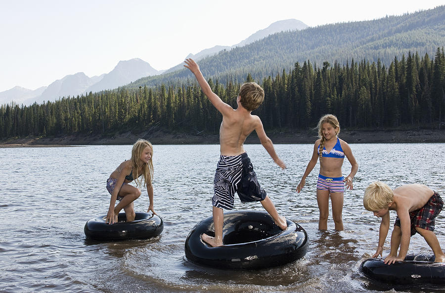 Kids playing in lake Photograph by Darrin Klimek
