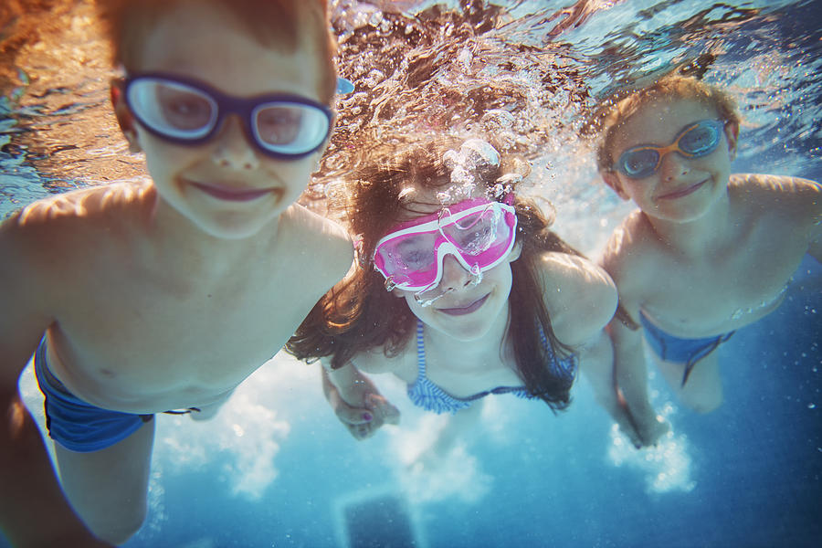 Kids swimming underwater Photograph by Imgorthand