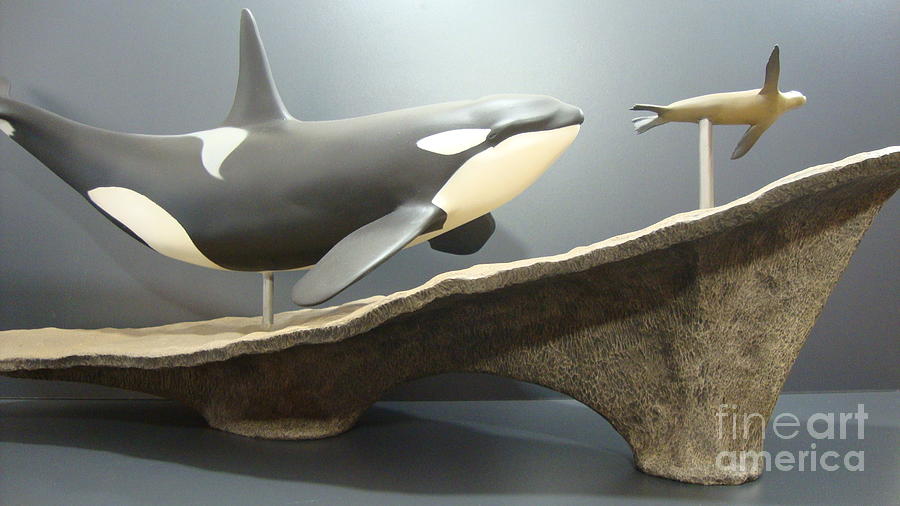killer whale and sea lion. Hunting on the beach. Sculpture  