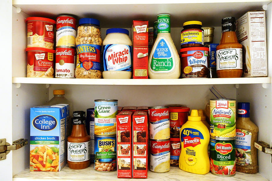 Kitchen pantry shelves filled with groceries Photograph by NoDerog