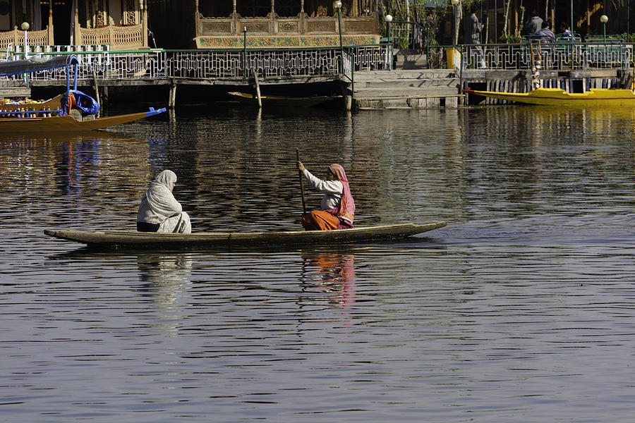 Ladies plying a small boat in the Dal Lake in Srinagar - in fron Photograph by Ashish Agarwal