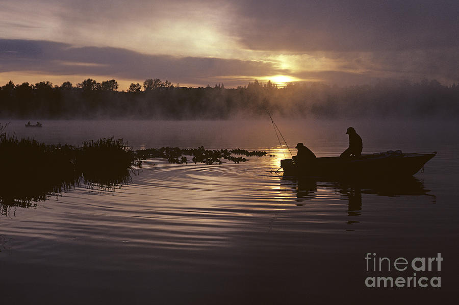 Lake Cassidy with silhouetted fishermen Photograph by Jim Corwin