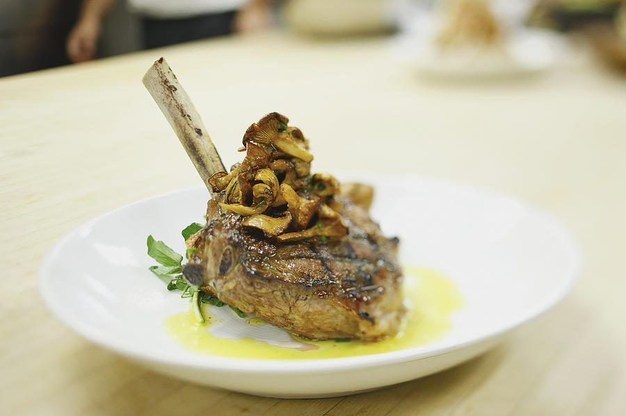 Vegetable Photograph - Lamb Chop On A Plate In A Restaurant by Eric Kulin