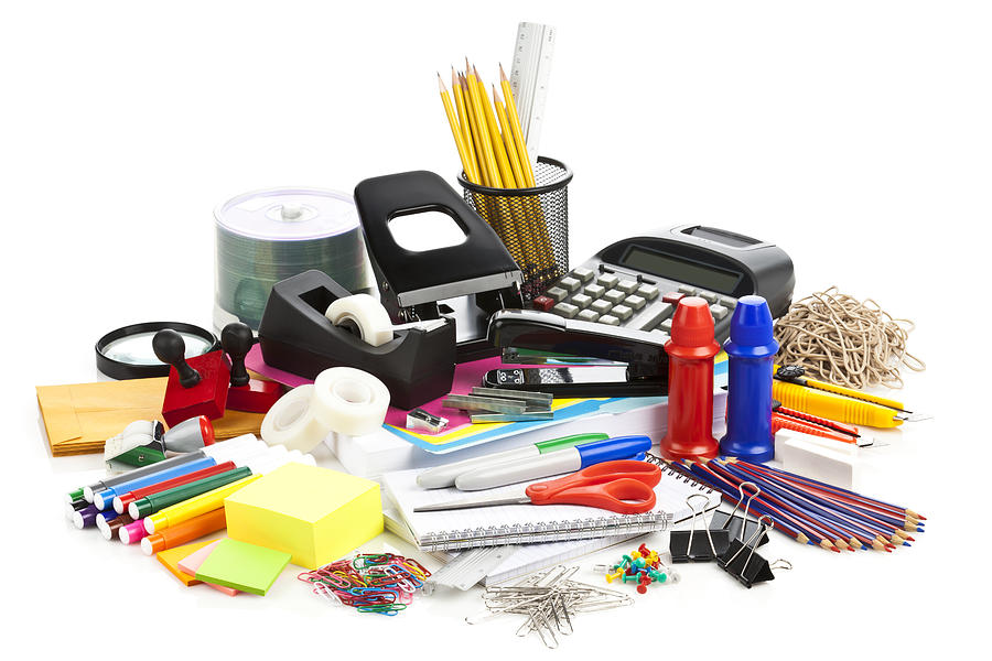 Large assortment of office supplies on white backdrop Photograph by Fcafotodigital