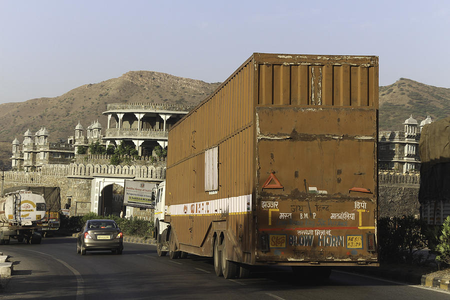Architecture Photograph - Large trailer and car on the highway on the outskirts of Udaipur by Ashish Agarwal