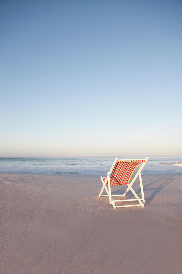Lawn Chair On Empty Beach Photograph by Zero Creatives