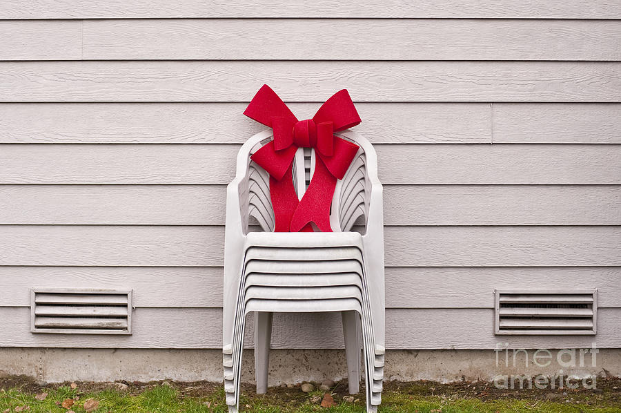 Lawn Chairs with red Christmas bow Photograph by Jim Corwin