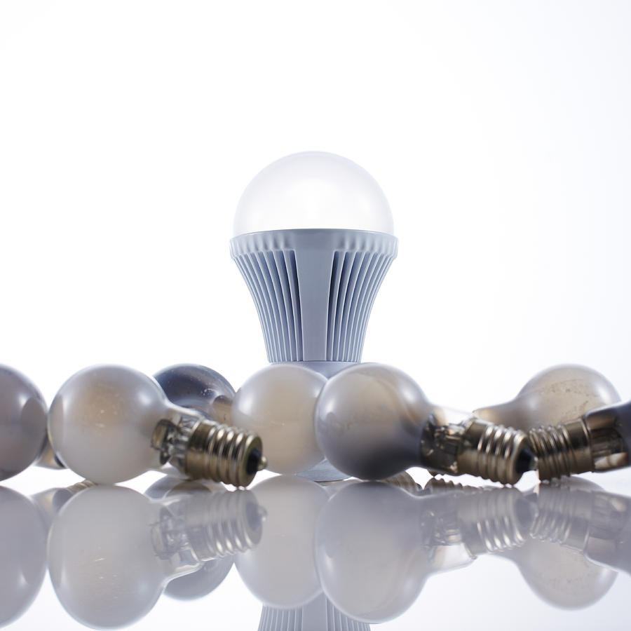 LED light bulb and old incandescent light bulbs Photograph by Ultra.f