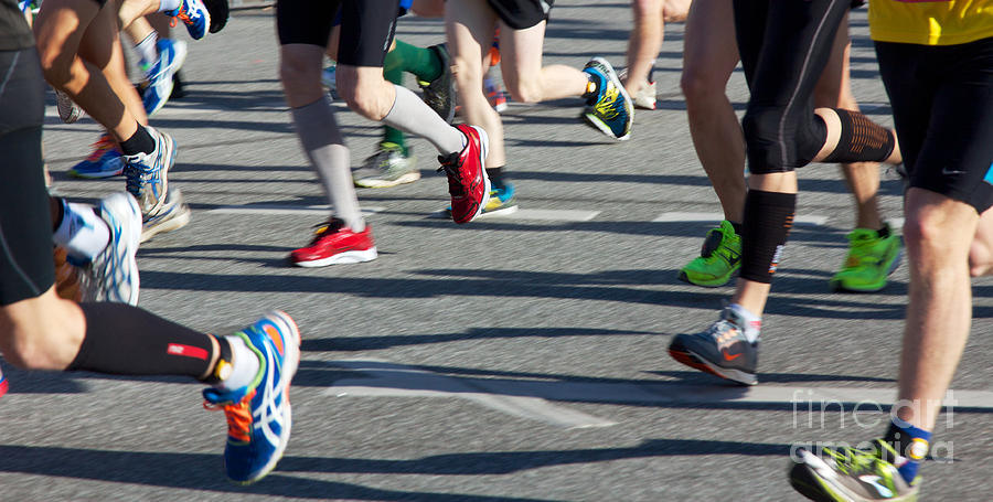 Athlete Photograph - Legs of Runners at Marathon by Jannis Werner
