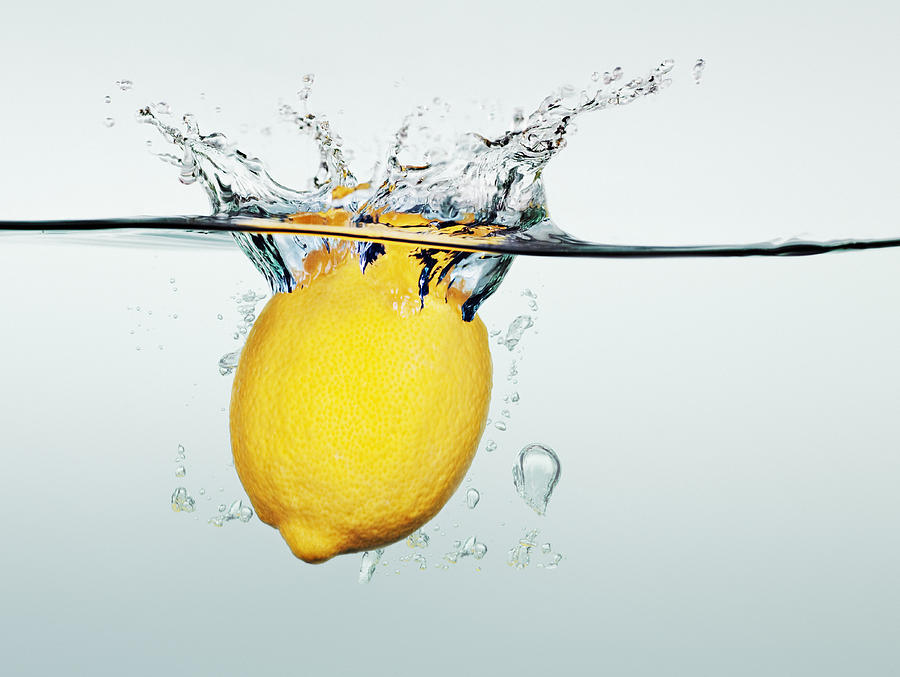 Lemon splashing in water Photograph by Martin Barraud