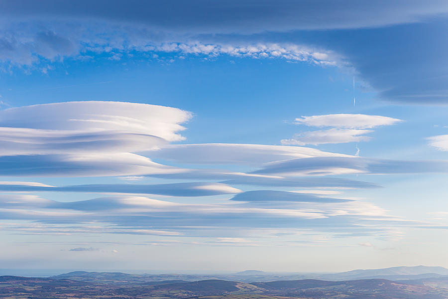 Lenticular clouds forming in the troposphere Photograph by Semmick Photo