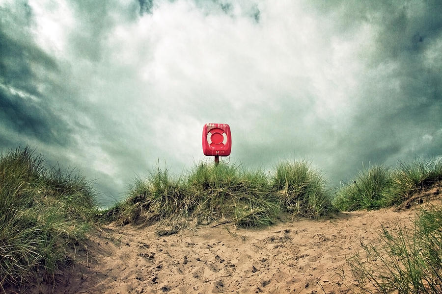 Life Buoy And Stormy Clouds Photograph by Image By Catherine Macbride