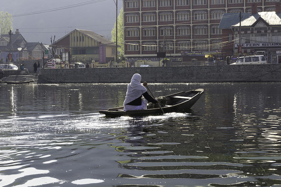 Landscape Photograph - Light following this lady on a wooden boat on the Dal Lake in Srinagar by Ashish Agarwal