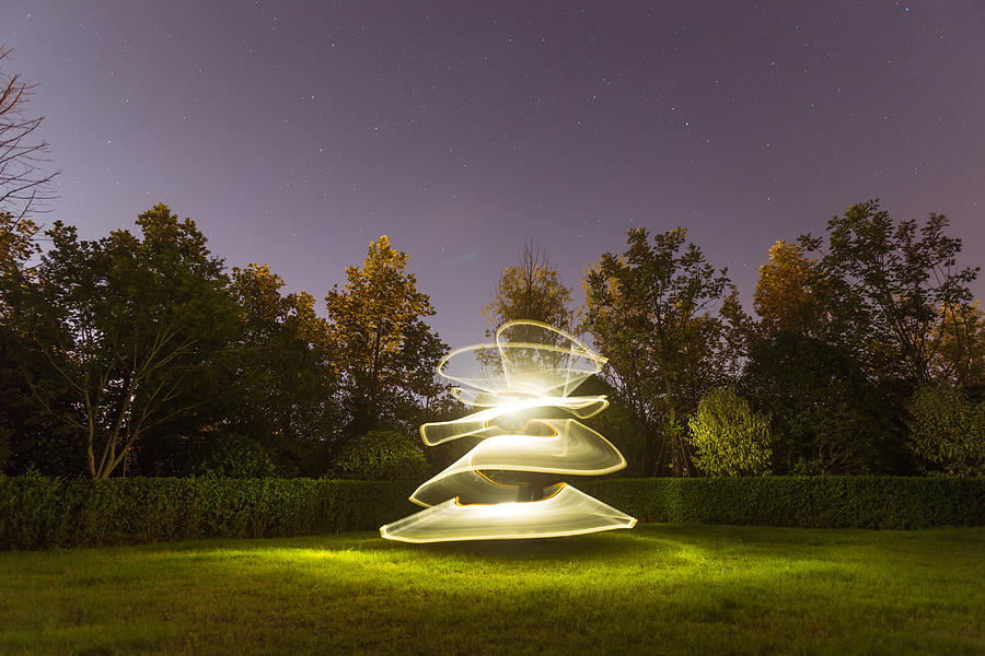 Light painting in the grass field in nature background Photograph by Xvision