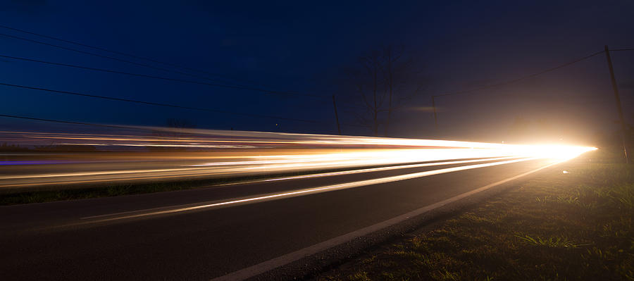Light trails from cars moving on a road Photograph by Macbrian Mun