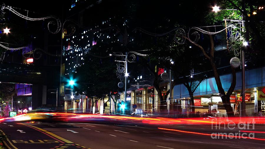 Light trails sweeping along the city streets Photograph by Scott Cameron