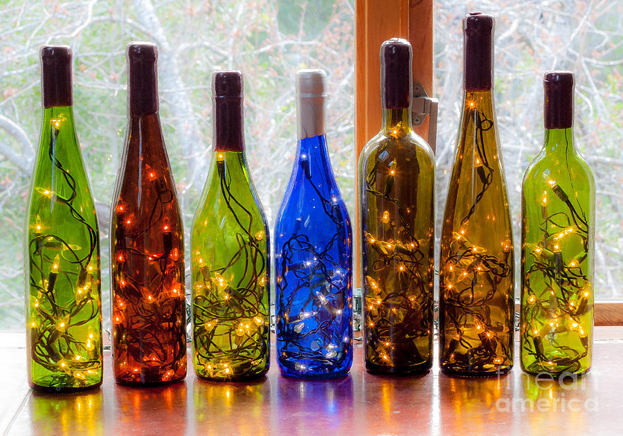 Lighted Wine Bottles Photograph by Margaret Hood