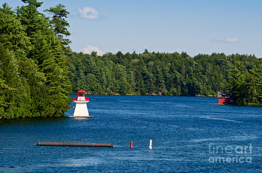 Lighthouse and boathouse Photograph by Les Palenik