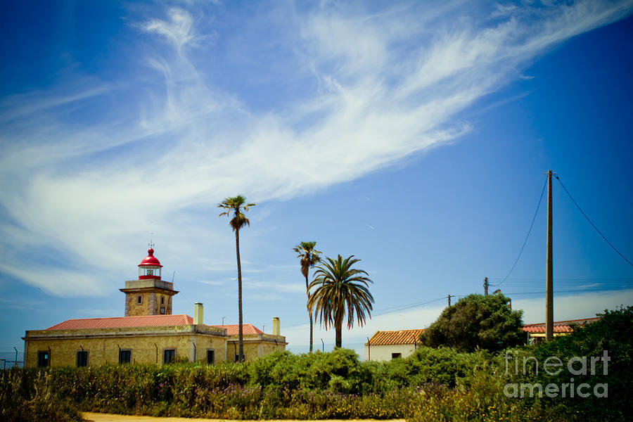 Lighthouse at Portugal coast Lagos Photograph by Raimond Klavins
