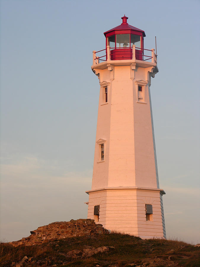 Lighthouse At Sunrise Photograph by Robert Lozen
