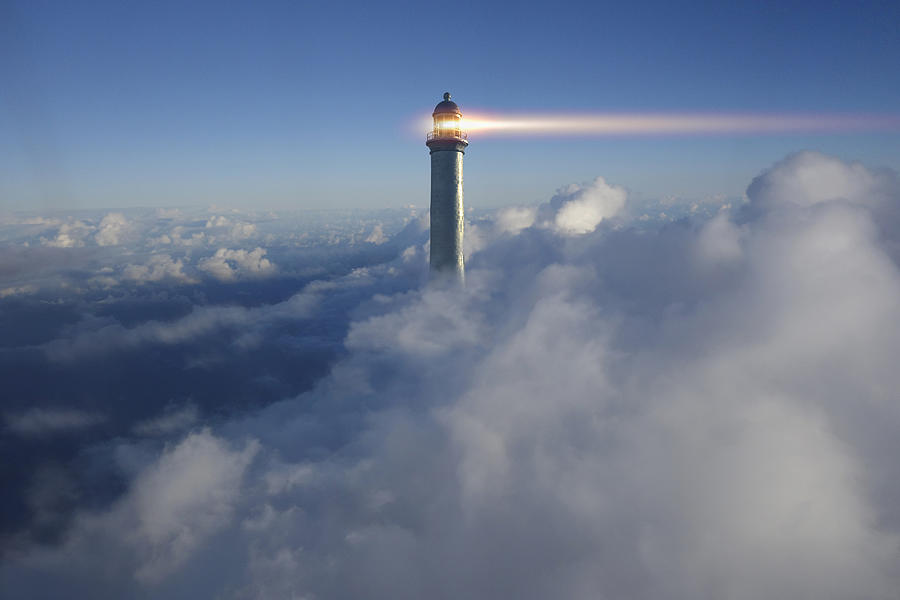 Lighthouse beaming above clouds in blue sky Photograph by Colin Anderson Productions Pty Ltd