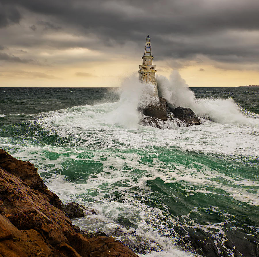 Lighthouse In A Stormy Sea Photograph