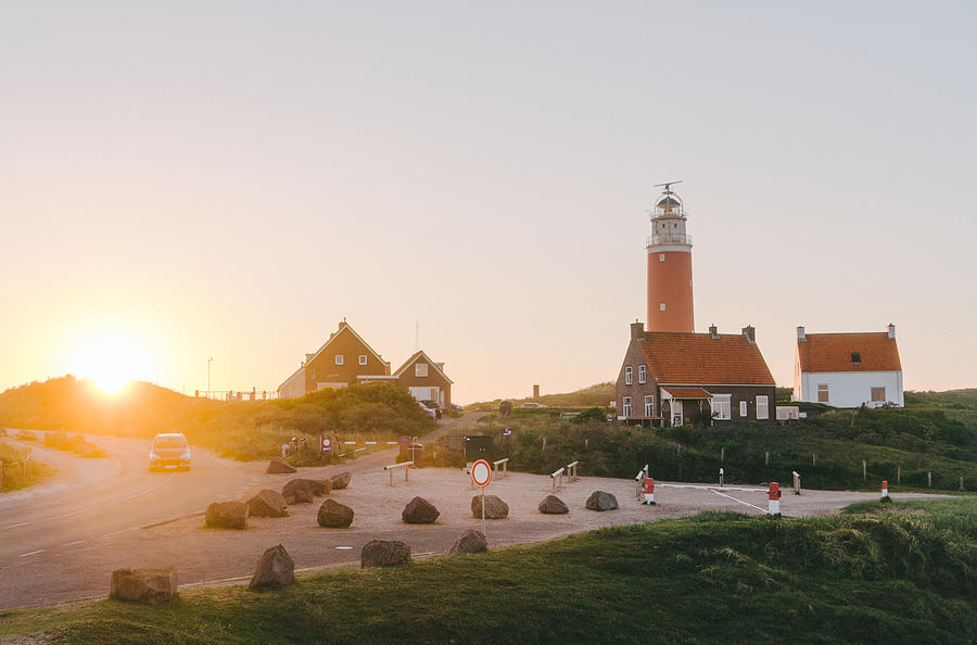 Lighthouse on Texel island at sunset Photograph by Oleh_Slobodeniuk