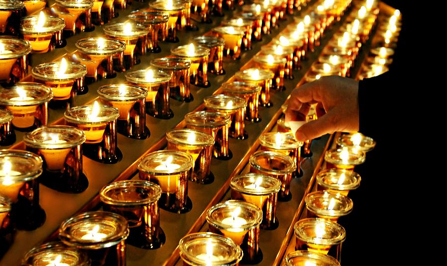 Lighting Prayer Candles Photograph by Diana Angstadt
