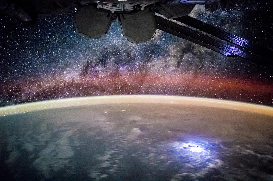 Lights Above And Below The Iss Photograph by Science Source