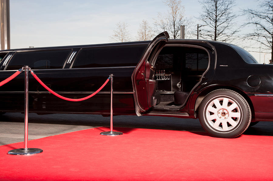 Limo with open door on red carpet Photograph by Robert Daly