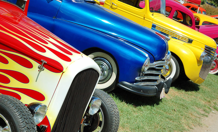 Line of hotrod cars in grass at car show Photograph by Purdue9394