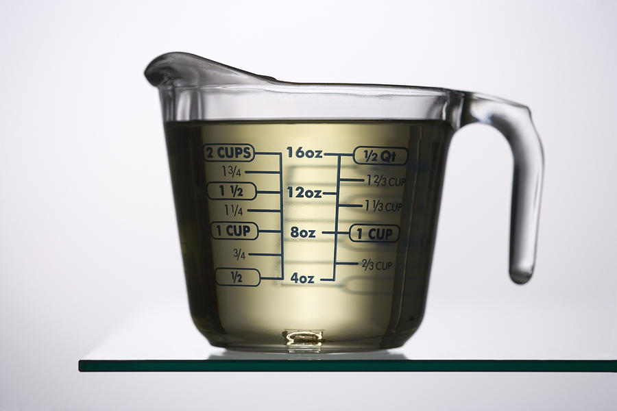 Liquid in a measuring jug Photograph by Photodisc