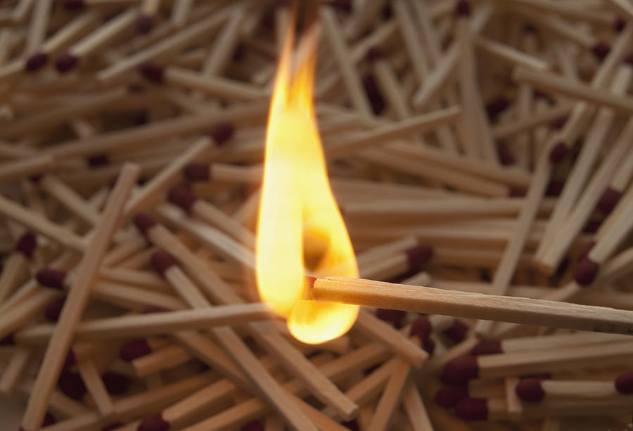Lit match on top of a pile of wooden matches Photograph by Mike Kemp