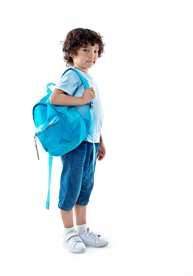 Little asian boy with schoolbag against white background Photograph by Baona